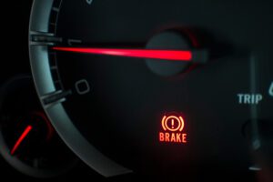 A close-up of a brake light on a dashboard.