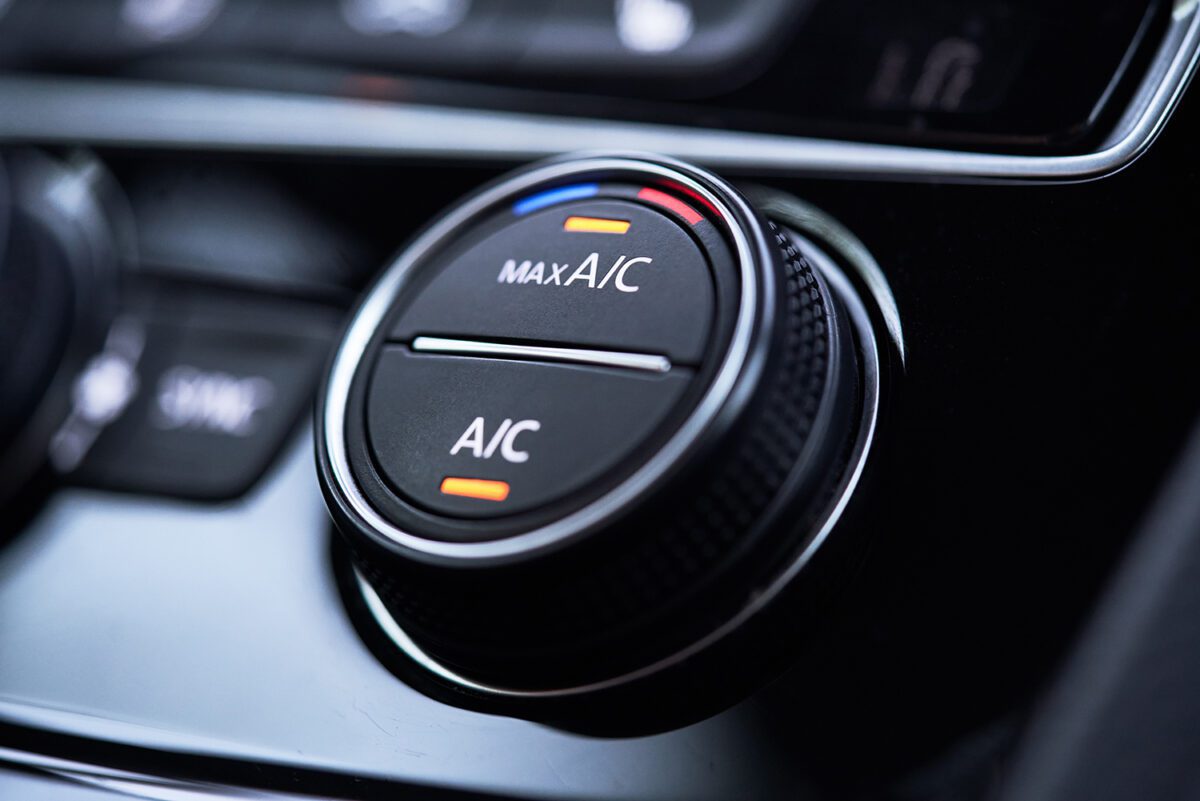An air conditioning dial in a car with the max air button on.